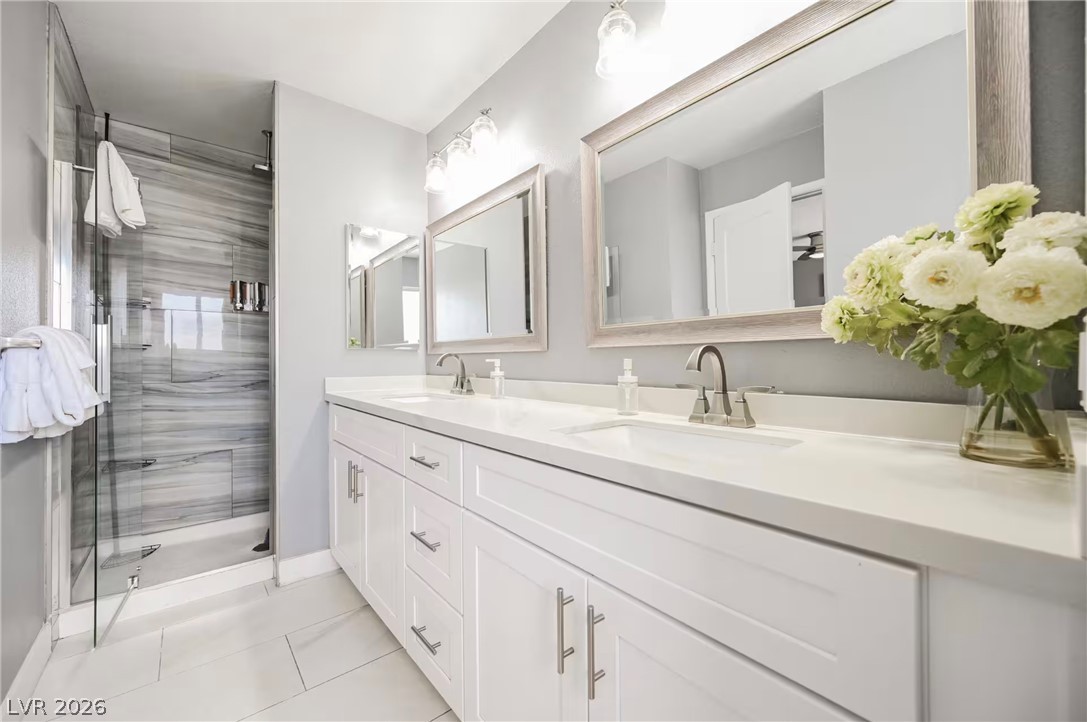 1803 Nuevo Road Henderson, NV 89014 - Photo 36 of 71 Bathroom with double vanity, a stall shower, and light tile patterned flooring