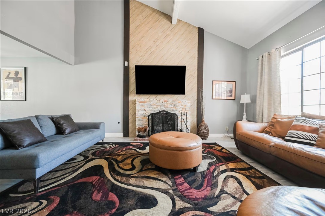 1803 Nuevo Road Henderson, NV 89014 - Photo 4 of 71 Living room featuring lofted ceiling and a fireplace