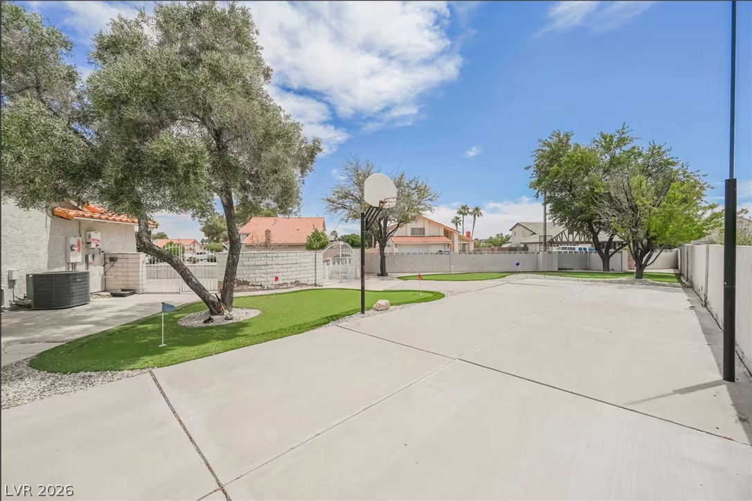 1803 Nuevo Road Henderson, NV 89014 - Photo 49 of 71 View of sport court featuring a residential view, a fenced backyard, and an area to practice putting