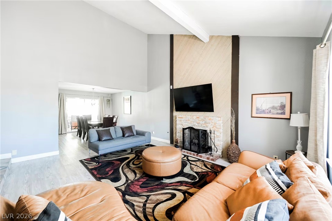 1803 Nuevo Road Henderson, NV 89014 - Photo 5 of 71 Living area with light wood-style floors, a fireplace, and lofted ceiling