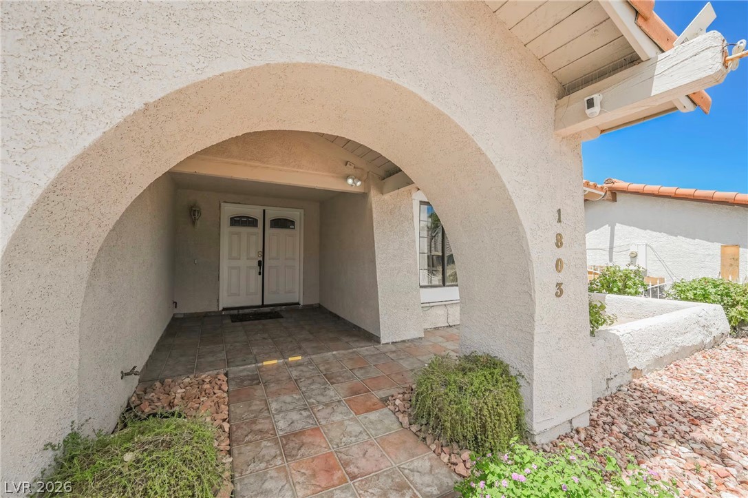 1803 Nuevo Road Henderson, NV 89014 - Photo 53 of 71 View of exterior entry featuring stucco siding
