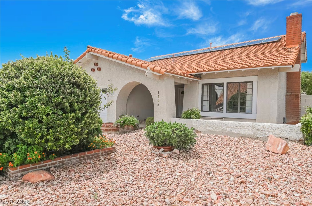 1803 Nuevo Road Henderson, NV 89014 - Photo 54 of 71 Mediterranean / spanish-style home featuring solar panels, stucco siding, a chimney, and a tiled roof