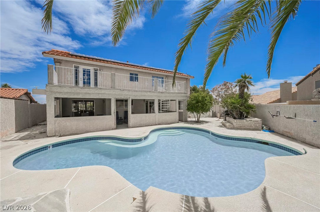 1803 Nuevo Road Henderson, NV 89014 - Photo 60 of 71 View of swimming pool with a balcony, patio surround, and a fenced backyard