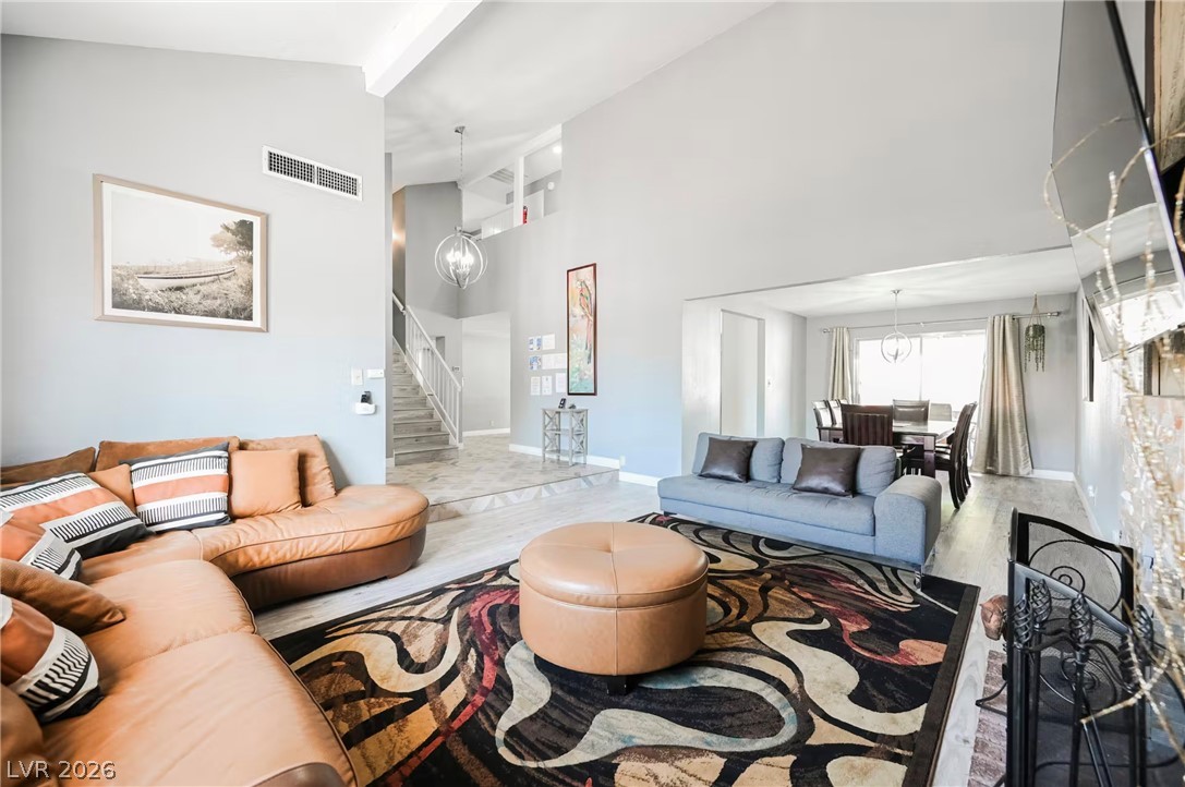 1803 Nuevo Road Henderson, NV 89014 - Photo 6 of 71 Living room with hanging lights, wood finished floors, and lofted ceiling