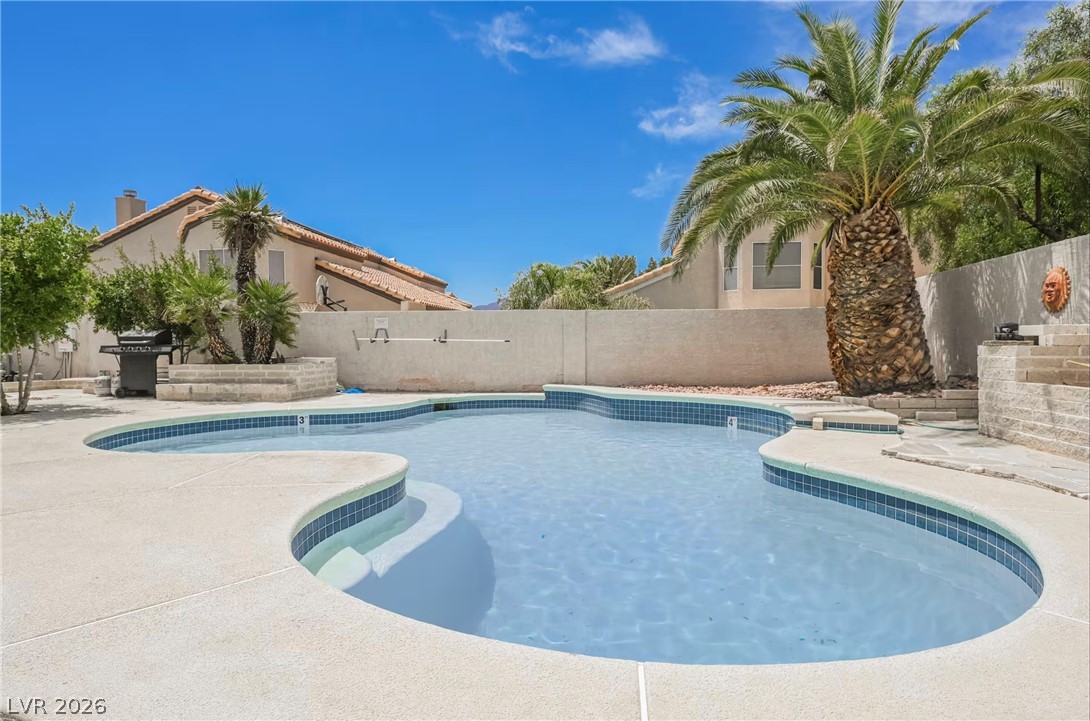 1803 Nuevo Road Henderson, NV 89014 - Photo 63 of 71 View of pool featuring patio surround, grilling area, and a fenced backyard