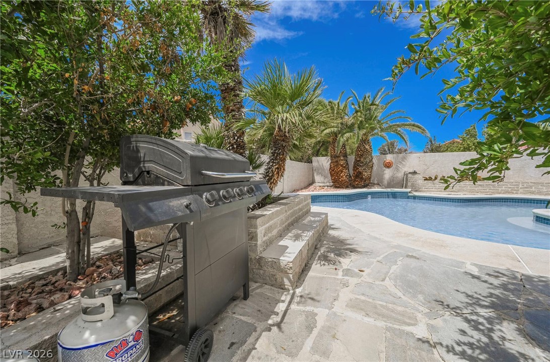 1803 Nuevo Road Henderson, NV 89014 - Photo 64 of 71 View of swimming pool with a grill, patio surround, and a fenced backyard