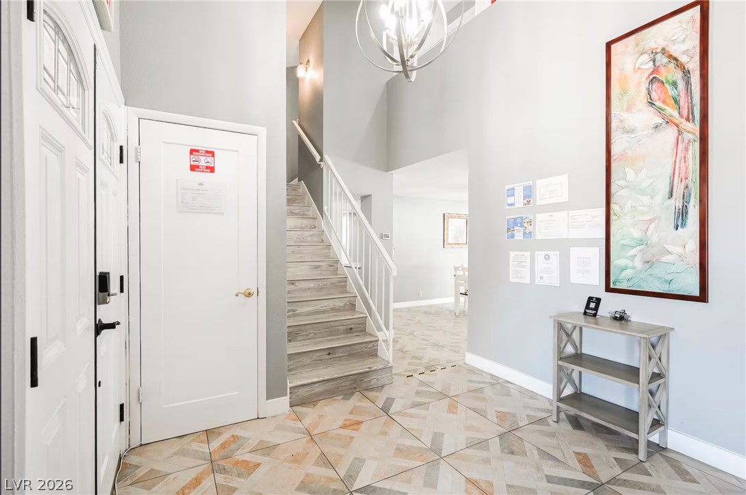 1803 Nuevo Road Henderson, NV 89014 - Photo 69 of 71 Entrance foyer with a chandelier and a high ceiling