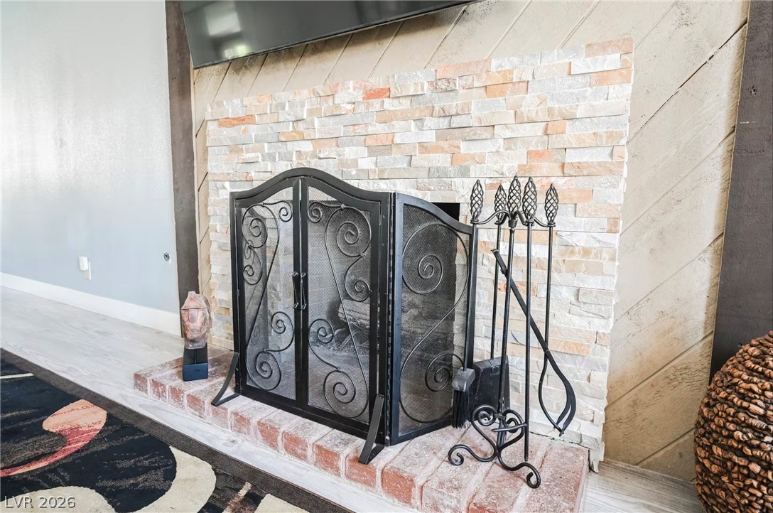 1803 Nuevo Road Henderson, NV 89014 - Photo 8 of 71 Detailed view of wood finished floors and a brick fireplace