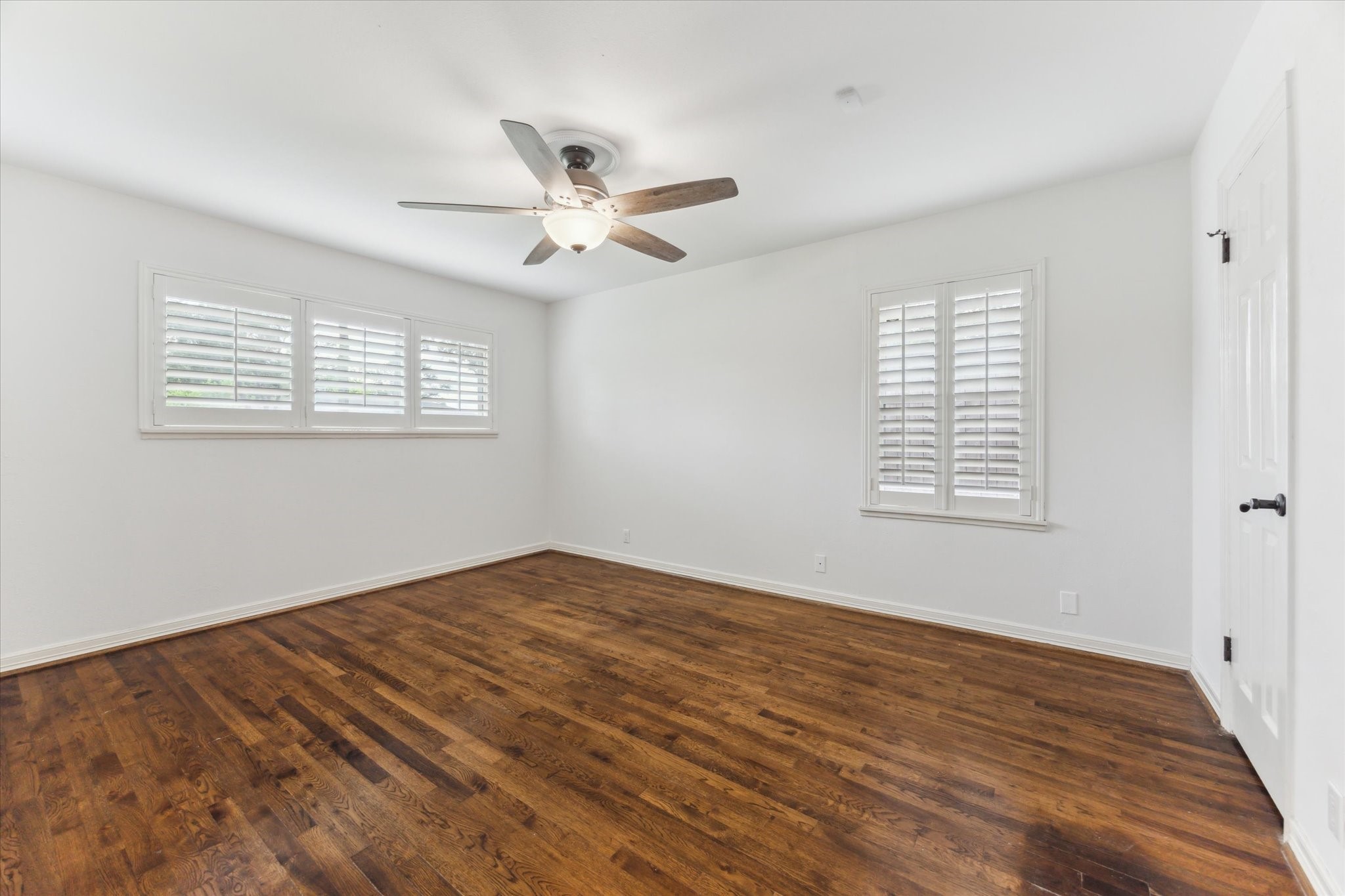 1402 Lehman Street Houston, TX 77018 - Photo 23 of 29 Primary bedroom featuring wood floors and plantation shutters installed on the replacement windows.