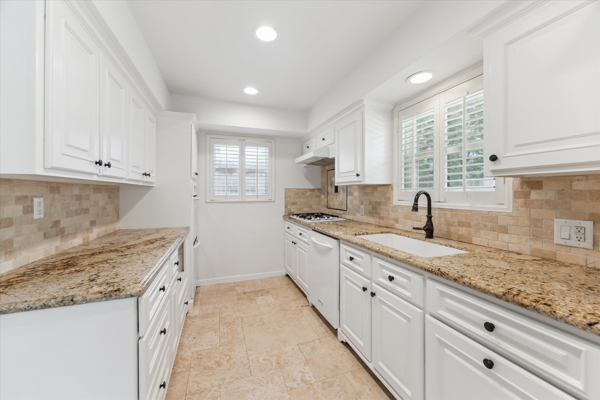 1402 Lehman Street Houston, TX 77018 - Photo 6 of 29 Kitchen with granite counters and gas cooktop. Interior windows have plantation shutters.