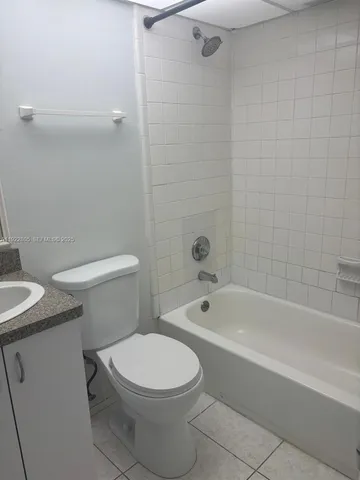 a bathroom with a toilet a sink and bathtub