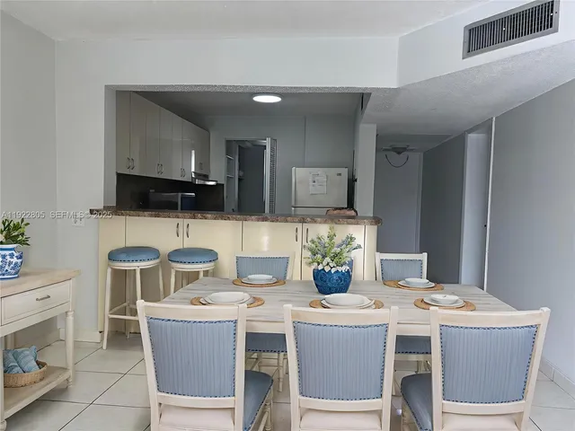 a kitchen with a stove a table and chairs
