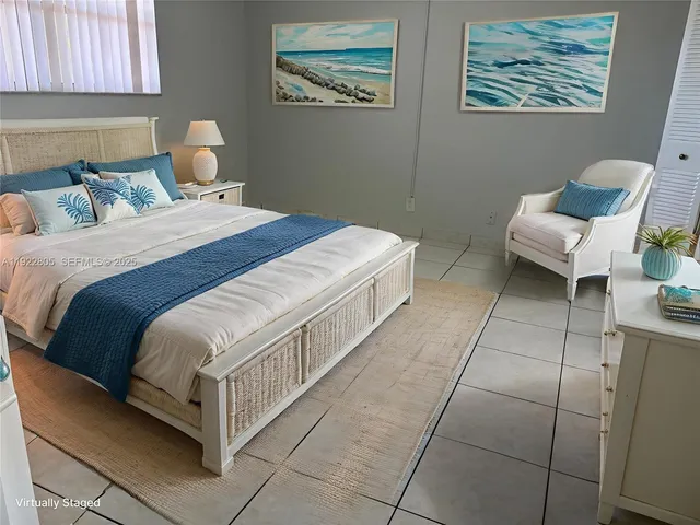 a bedroom with a bed and a chair