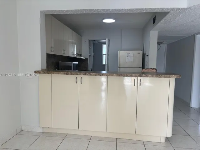 a kitchen with white cabinets