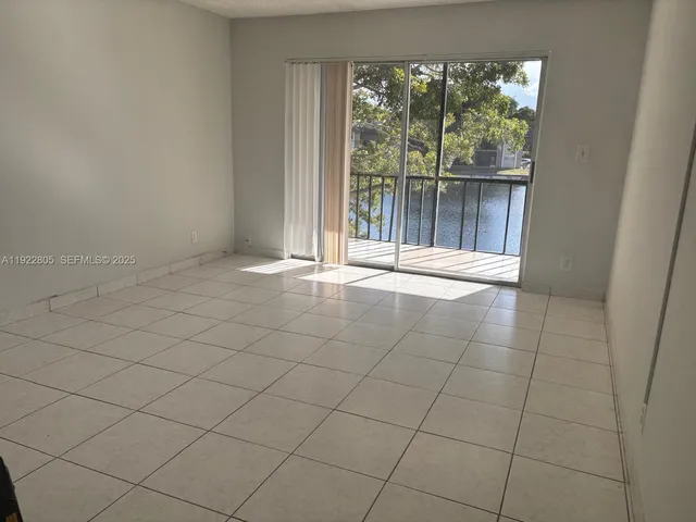 a view of an empty room and a window