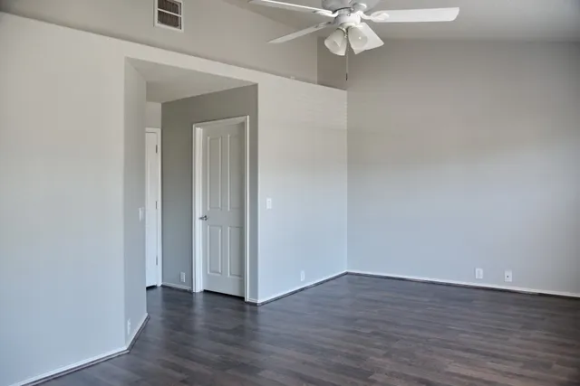 a view of an empty room with wooden floor