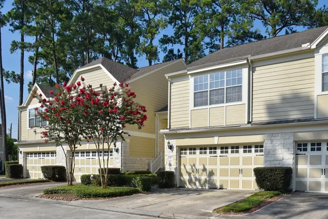 a front view of a house with a tree