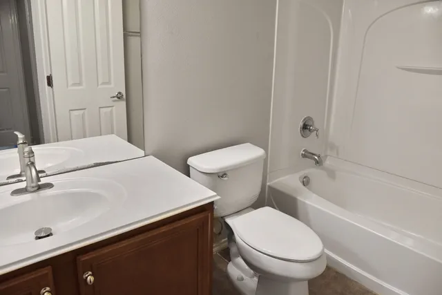 a white toilet sitting next to a bathroom sink