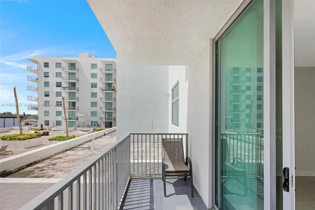 a view of balcony with a couple of large trees