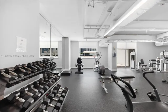 a room with gym equipment and a large window
