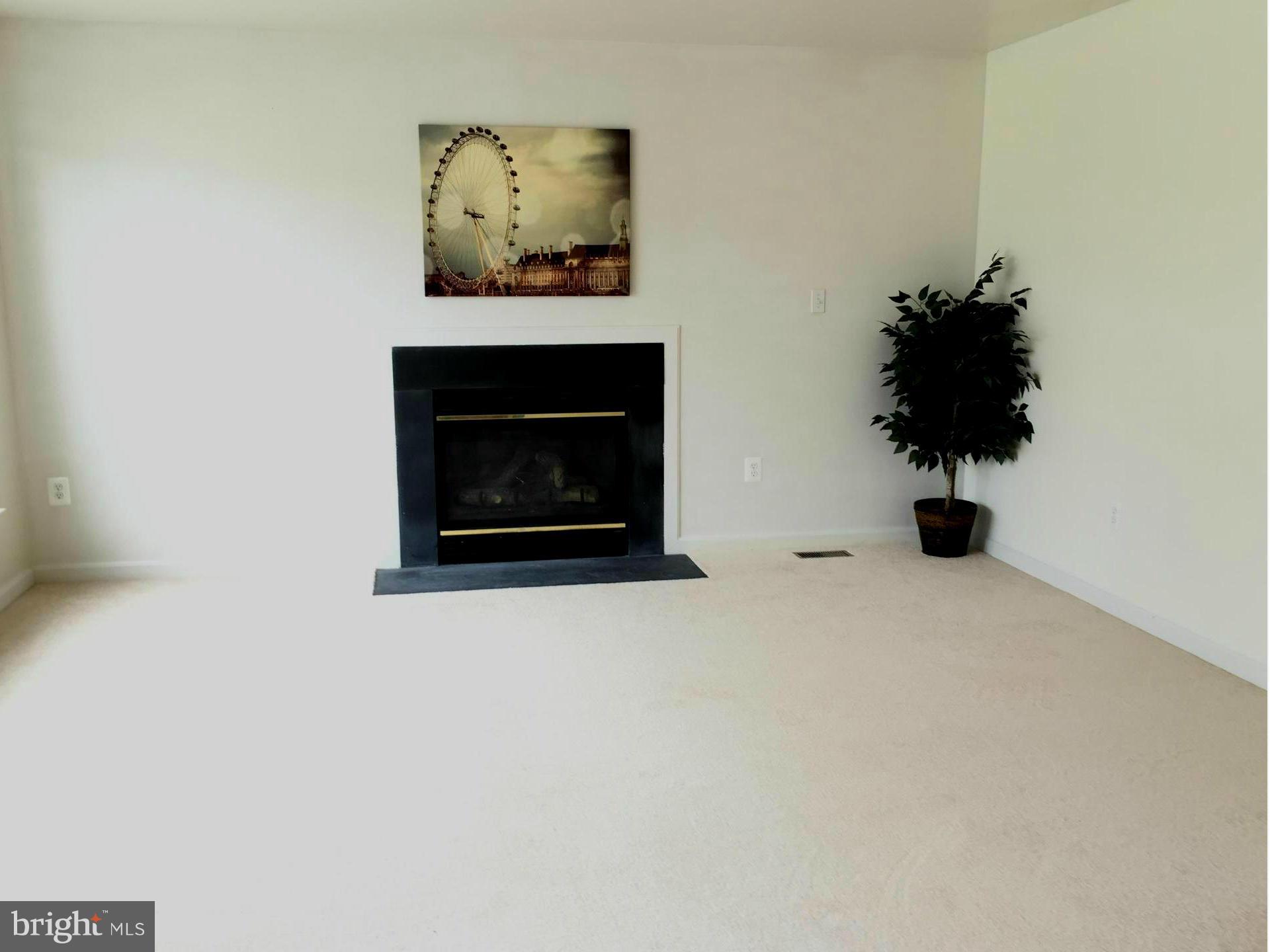 116 Commodore Drive Baltimore, MD 21221 - Photo 11 of 25 a living room with furniture and a fireplace