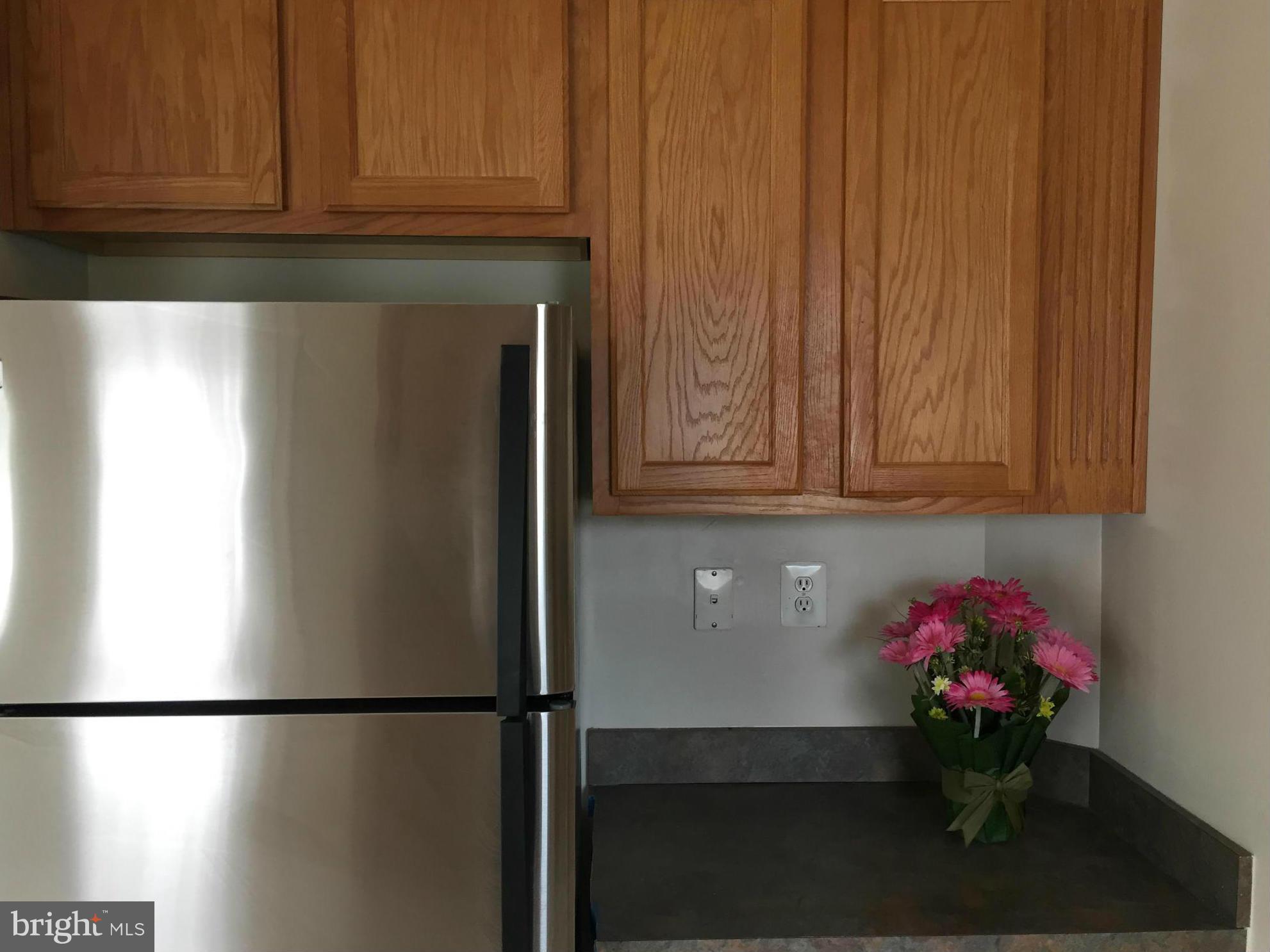 116 Commodore Drive Baltimore, MD 21221 - Photo 14 of 25 a kitchen with a refrigerator and cabinets