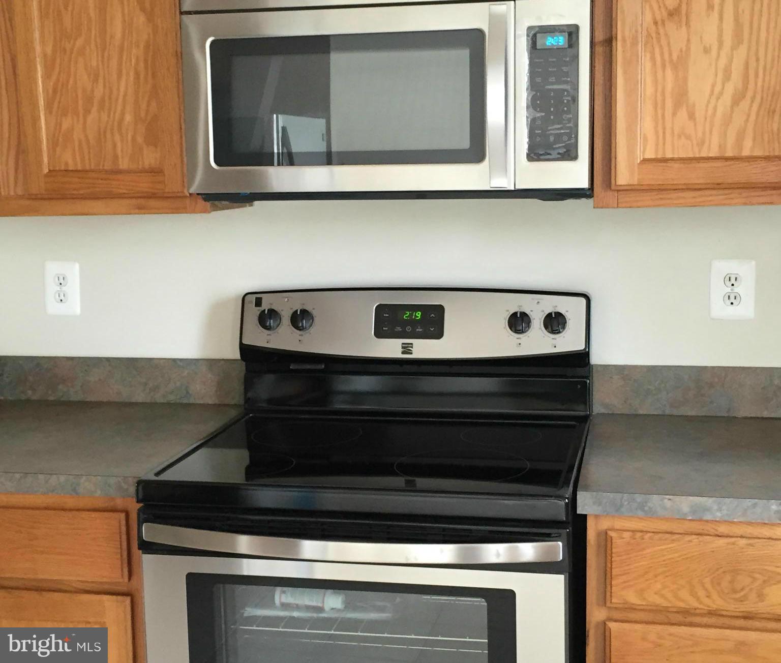 116 Commodore Drive Baltimore, MD 21221 - Photo 15 of 25 a stove top oven sitting inside of a kitchen