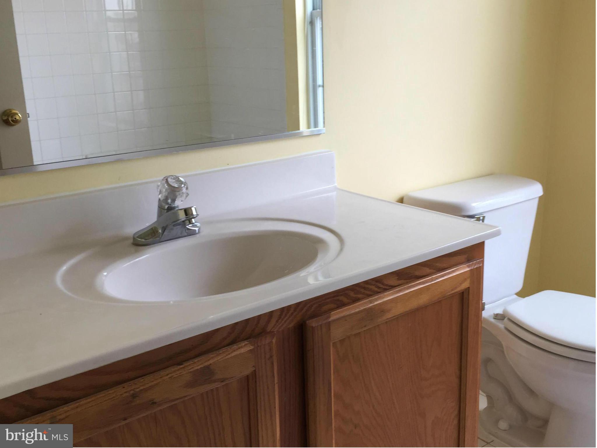 116 Commodore Drive Baltimore, MD 21221 - Photo 17 of 25 a close view of a sink and a washer and dryer