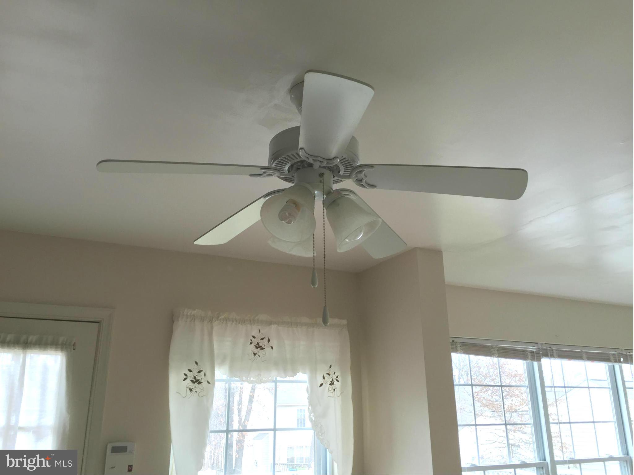 116 Commodore Drive Baltimore, MD 21221 - Photo 23 of 25 a room with a chandelier fan and windows