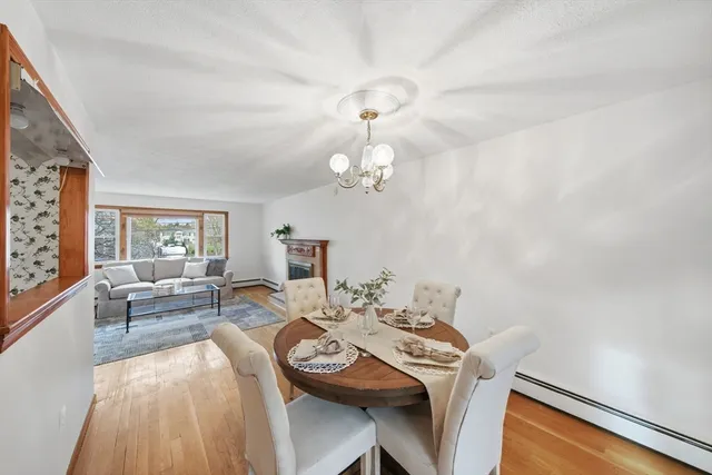a view of a dining room with furniture a chandelier and wooden floor