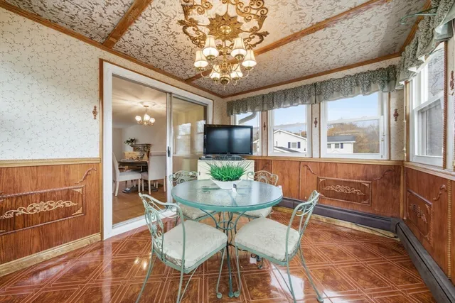 a dining room with furniture a potted plant and chandelier