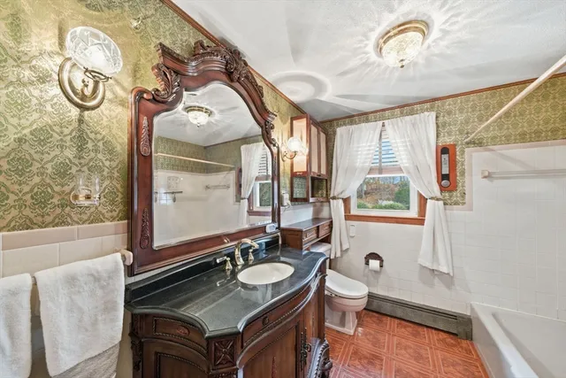 a bathroom with a sink a toilet and a mirror