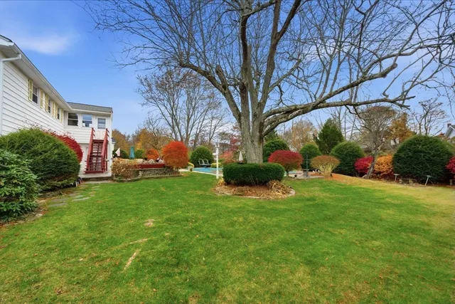 a view of house with yard and green space