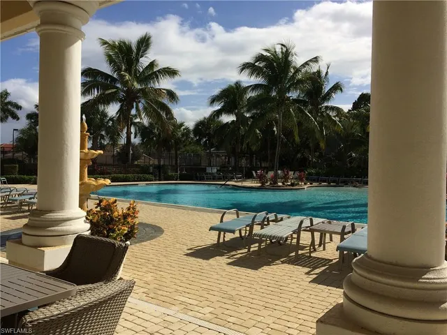 a view of a lake with couches and wooden floor