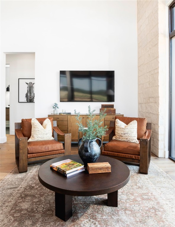 9361 Highway 290, Unit 107 Hye, TX 78635 - Photo 20 of 40 a living room with furniture a flat screen tv and a couch