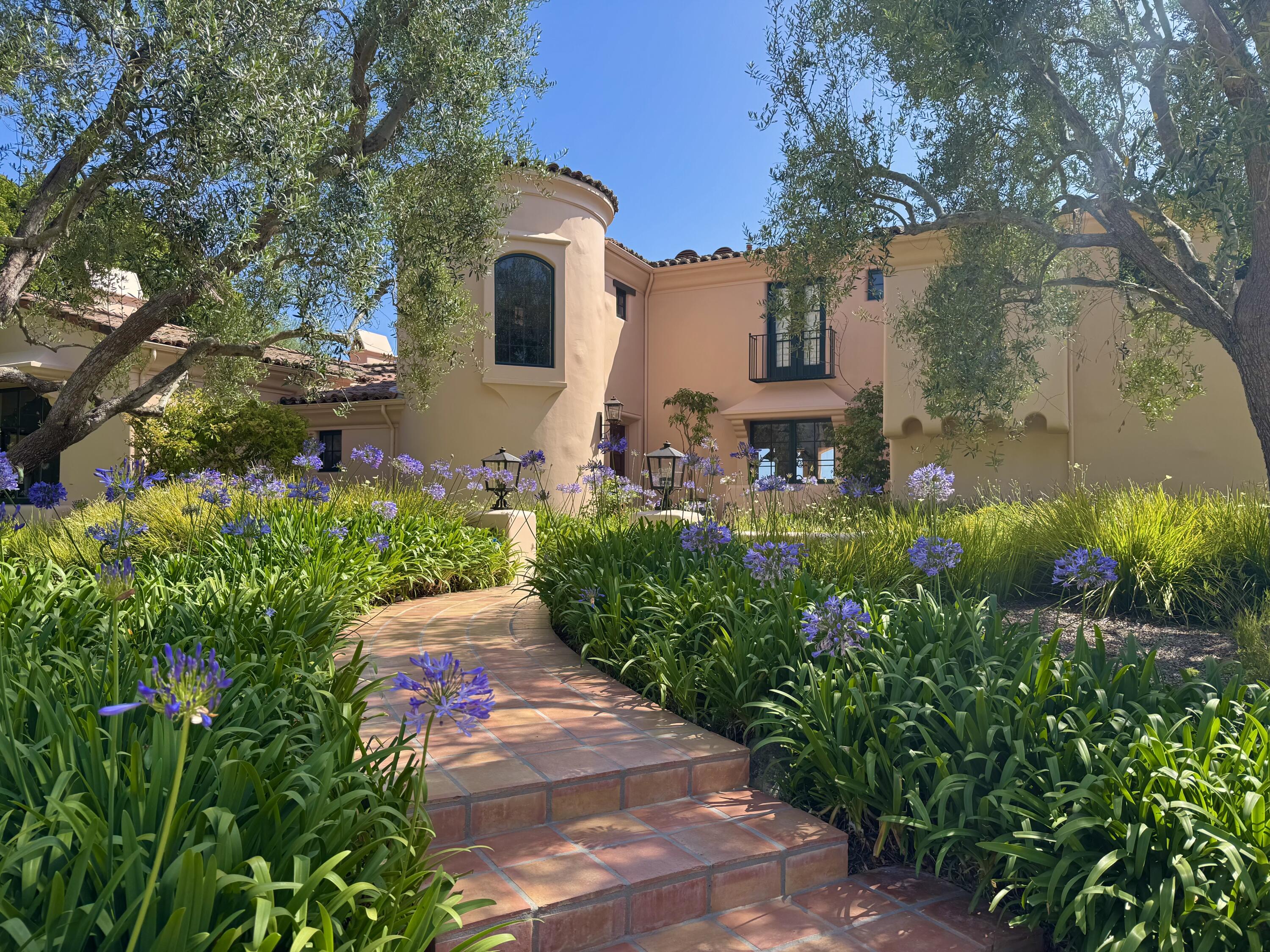 2240 Ortega Ranch Road Summerland, CA 93067 - Photo 2 of 93 a front view of a house with a yard and garden