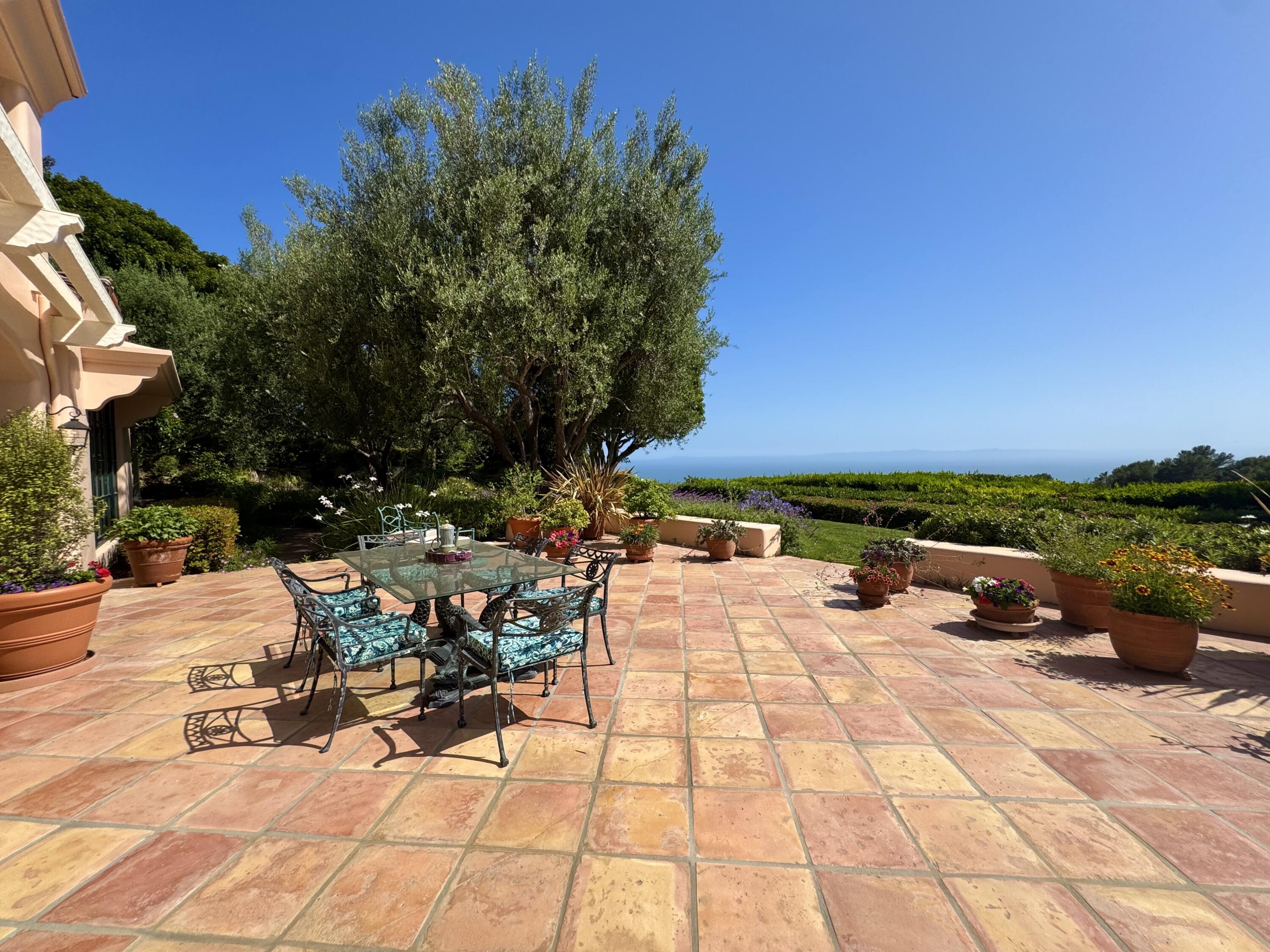 2240 Ortega Ranch Road Summerland, CA 93067 - Photo 66 of 93 a view of a patio with a table and chairs under an umbrella