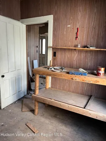 a view of kitchen with furniture and electronic appliances