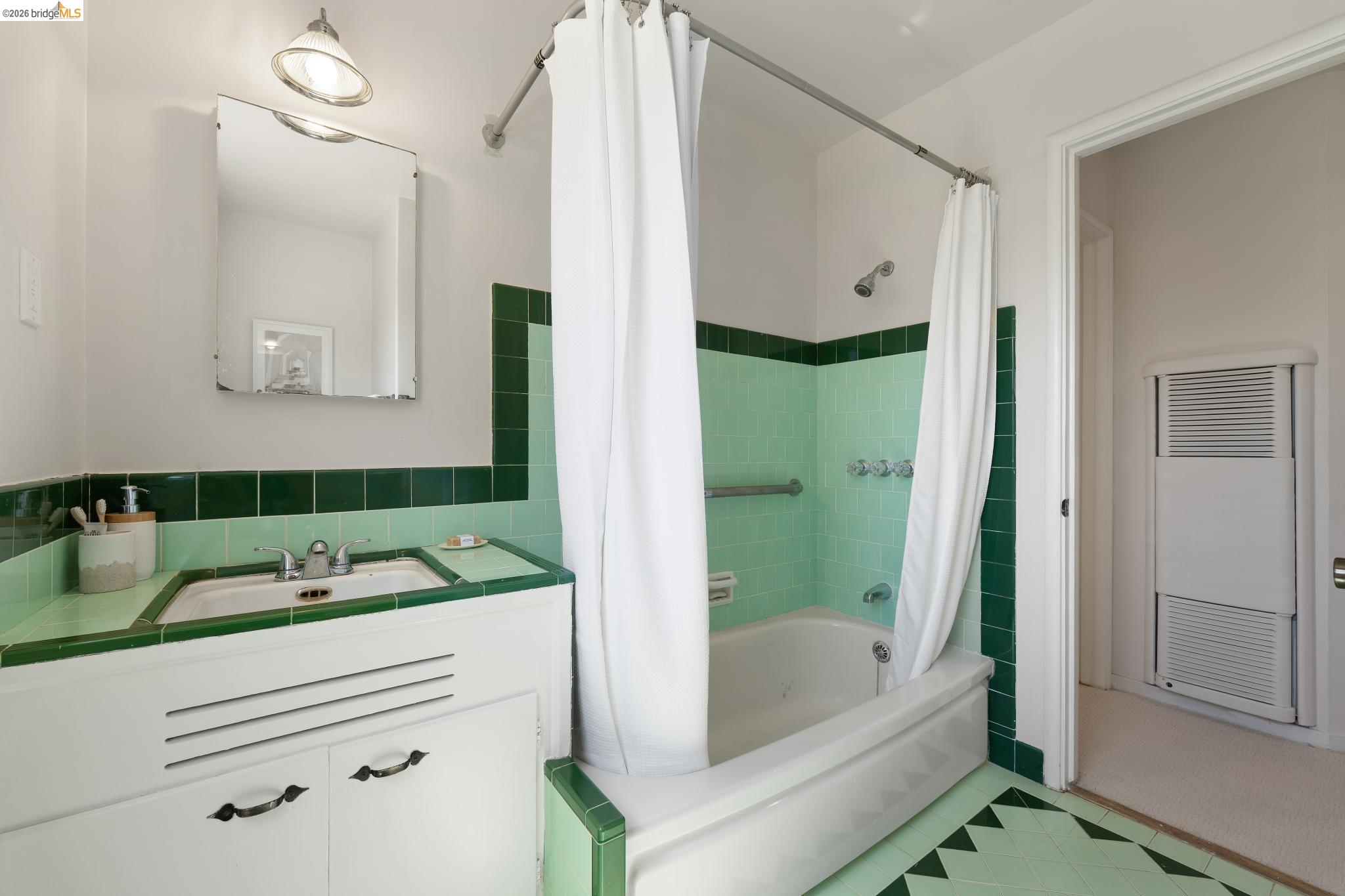 15162 Inverness Street San Leandro, CA 94579 - Photo 16 of 25 Bathroom featuring a built-in vanity with integrated sink, tiled countertop, and overhead lighting