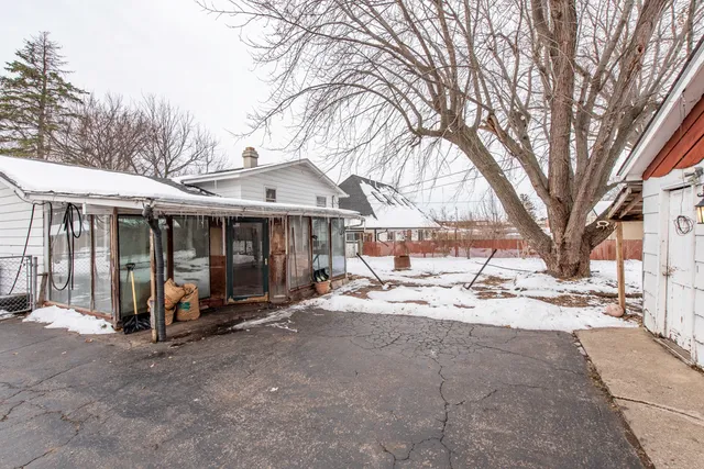 a view of a chair and tables in the patio