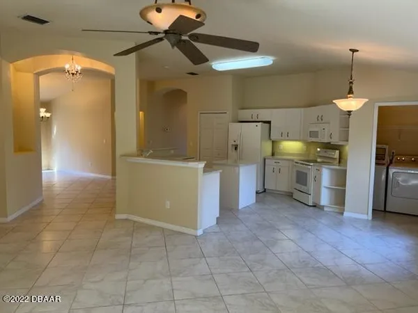 a view of a kitchen with a sink cabinets and wooden floor