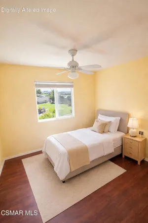 a bedroom with bed and window
