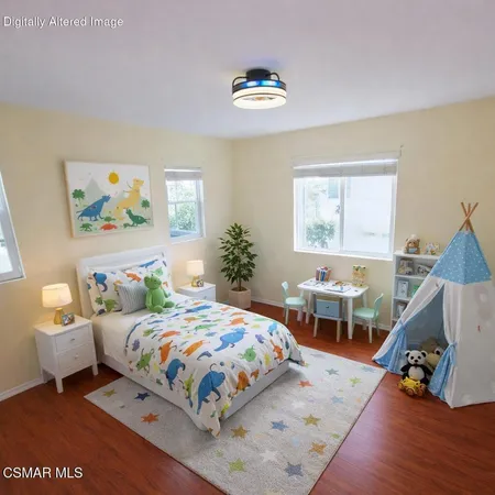 a bedroom with a bed and a wooden floor