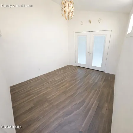 a view of a room with wooden floor