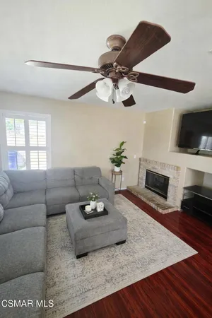 a living room with furniture a flat screen tv and a fireplace