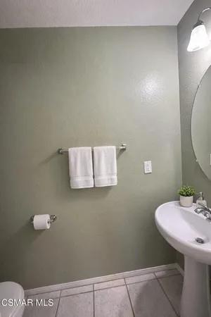 a bathroom with a sink mirror and toilet