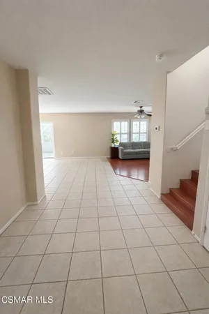 a view of a livingroom with an empty space and a window
