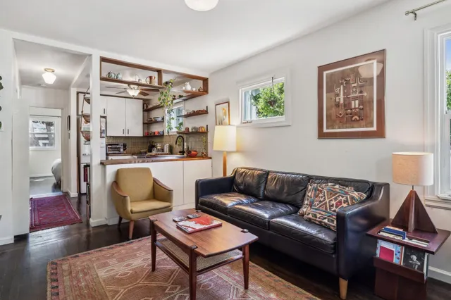a living room with furniture and a kitchen