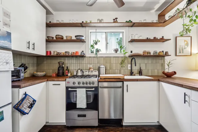 a kitchen with stainless steel appliances granite countertop a stove and a sink