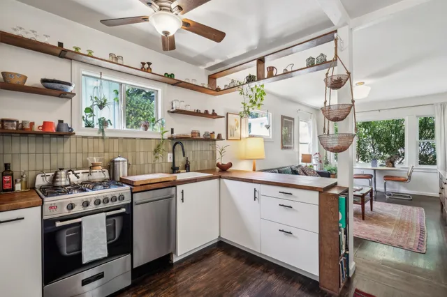 a kitchen with a stove window and cabinets